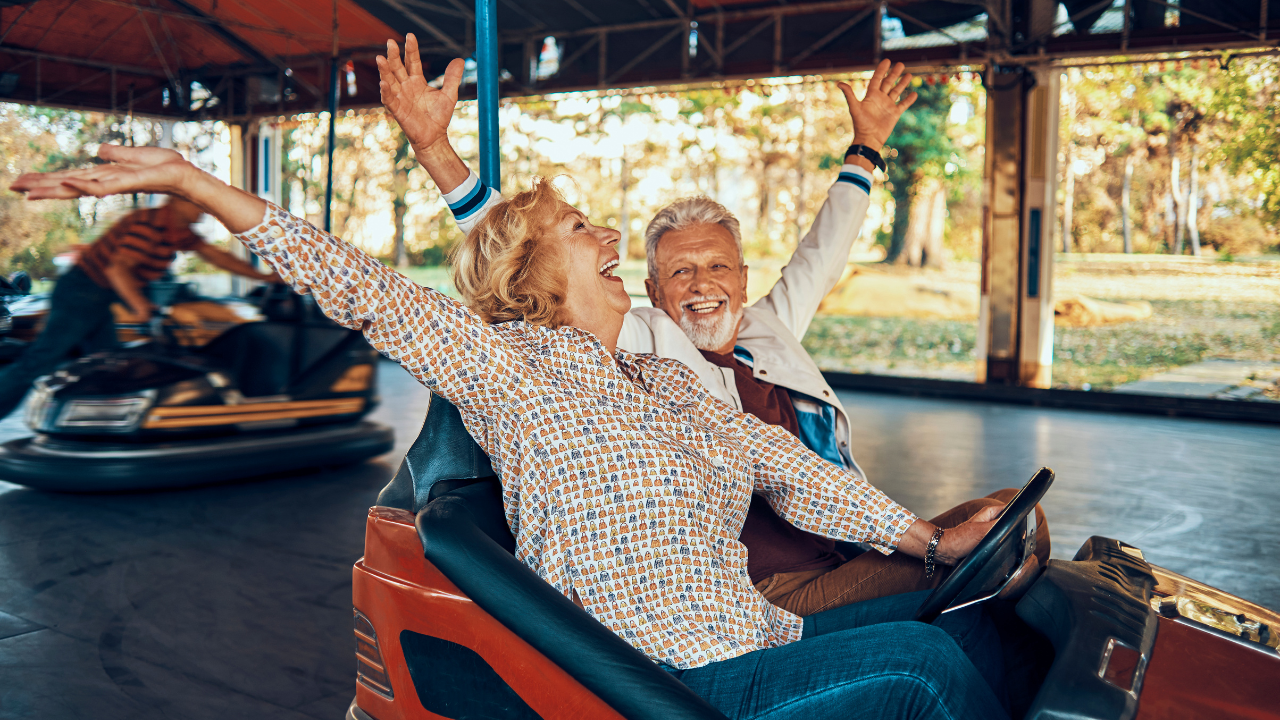 retired couple riding bumper cars